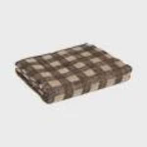 May include: A folded brown and tan plaid blanket. The blanket features a large-scale checkered pattern. The fabric appears soft and cozy, suitable for use as a throw or for layering on a bed. The blanket is rectangular in shape.