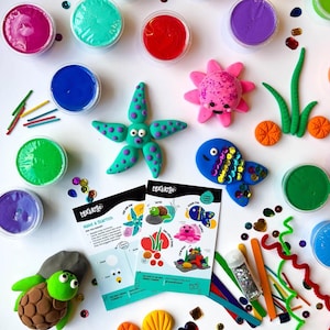 May include: A craft kit for making sea creatures out of clay. The kit includes colourful clay, glitter, sequins, and instructions for making a starfish, turtle, fish, and octopus. The kit also includes a small container of glitter.