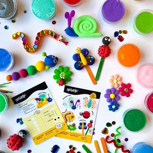 May include: A set of colourful play dough with instructions for making a caterpillar, butterfly, ladybug, and snail. The set includes various colours of play dough, googly eyes, glitter, and craft sticks.