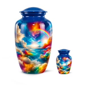 May include: Two blue cremation urns. The larger urn is approximately 10 inches tall, and the smaller one is about 5 inches tall. Both urns feature a vibrant, colorful design of a rainbow, clouds, and a bright sky.
