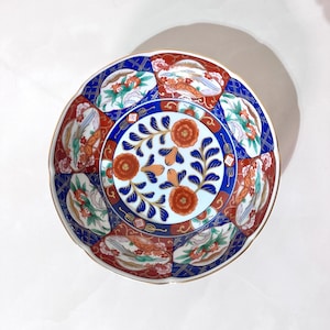 May include: A set of three ceramic mugs with a speckled, matte finish. The mugs are in shades of cream, light gray, and dark gray. Each mug has a simple, minimalist design, perfect for coffee or tea.