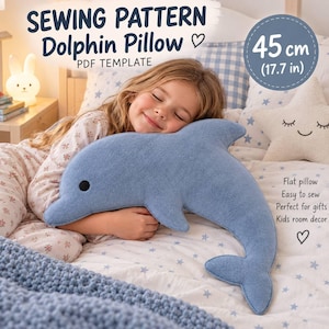May include: A blue dolphin-shaped pillow with a black eye, measuring 45 cm (17.7 inches). The text reads: SEWING PATTERN Dolphin Pillow PDF TEMPLATE, 45 cm (17.7 in), Flat pillow, Easy to sew, Perfect for gifts, Kids room decor.