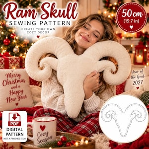 May include: A cream-colored, plush ram skull-shaped pillow with large, curved horns. The image includes text reading Ram Skull Sewing Pattern, 50 cm (19.7 in), Year of the Goat 2027, and a circular diagram showing the outline of the ram skull shape.