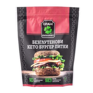 May include: A black and red package of keto burger buns. The package features a graphic of a burger with lettuce, tomato, cheese, and a patty. Text on the package includes "GRAM 3a KILOGRAM" and "GLUTEN FREE KETO BURGER BUNS."