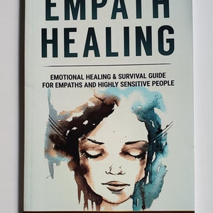 May include: Book cover with the title "Empath Healing: Emotional Healing & Survival Guide for Empaths and Highly Sensitive People" by Marianne Gracie. The cover features a watercolor illustration of a woman with her eyes closed.