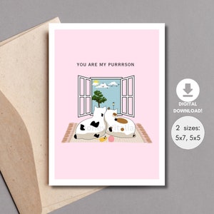 May include: A pink card with a white window and two cats looking out at a blue sky with clouds. The text on the card reads "You are my purrrson".