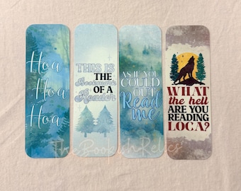 May include: Set of four watercolor bookmarks with different quotes about reading. The bookmarks feature a blue and white watercolor background with trees and a wolf illustration. The quotes are "How Hoa Hoa", "This is the bookmark of a reader", "As if you could out read me", and "What the hell are you reading loca?"