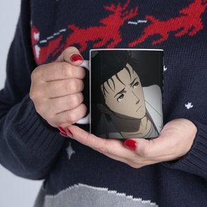 May include: White ceramic mug featuring a black and white image of an anime character with black hair and a white shirt. The character has a serious expression on their face.