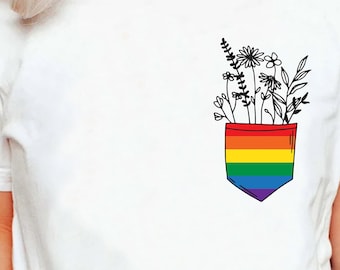 May include: White t-shirt with a rainbow pocket and a black line drawing of flowers coming out of the pocket.