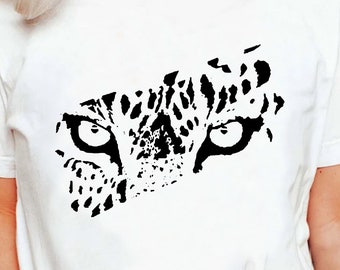 May include: A white t-shirt with a black and white graphic of a leopard's eyes.