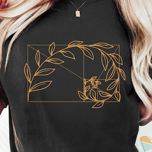 May include: A black t-shirt with a gold outline of a leaf design that incorporates the Fibonacci sequence.