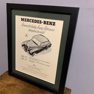 May include: A vintage black and white advertisement for Mercedes-Benz featuring a black car with the text "Mercedes-Benz" and "Concerned for quality, beauty, performance throughout the world" in a cursive font. The ad also includes the text "Type 300" and "Type 220".