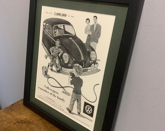 May include: A black and white vintage advertisement for the Volkswagen Beetle. The ad features a family of four standing in front of the car. The text reads "Now over 2,000,000 in use" and "Volkswagen - a member of the family".