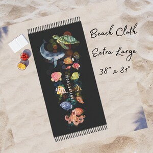 May include: Black beach towel with a colorful underwater scene featuring a whale, octopus, sea turtles, and fish. The towel has the text "More Friends" and measures 38 inches by 81 inches.