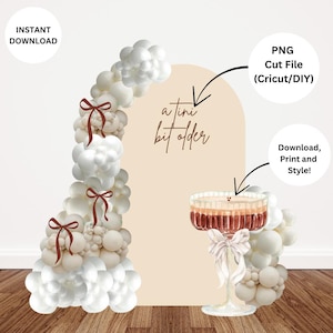 May include: A digital design featuring a champagne-style cocktail in a decorative glass, a balloon arch, and the text "a tini bit older." The design includes the text "Instant Download," "PNG Cut File," and "Download, Print and Style!"