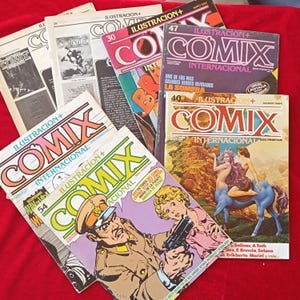 Pode incluir: Uma coleção de revistas Comix Internacional com várias ilustrações de capa, incluindo um centauro, uma figura militar com uma pistola e uma tipografia gráfica ousada. As revistas estão empilhadas e sobrepostas, exibindo números e títulos.