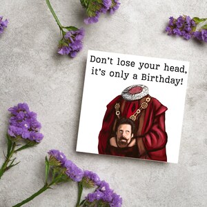 image of a square birthday card with the text 'don't lose your head, it's only a birthday' above an illustrated picture of headless Humphrey from the tv show ghosts in his red period clothing holding his head looking up at his body