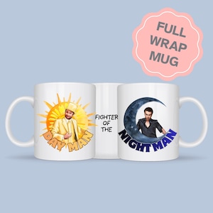 May include: A white ceramic mug featuring a full wrap design. One side shows a person in a yellow suit inside a yellow sun with the text DAY MAN. The other side shows a person in a black shirt inside a blue crescent moon with the text NIGHT MAN. The centre text reads FIGHTER OF THE.