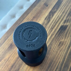 May include: Black plastic bottle cap with the text "Gumpert Innovations LLC" and a lightning bolt logo. The number "0400" is printed on the bottom.