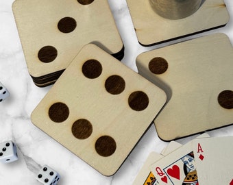 May include: Set of six wooden coasters with a dice design. Each coaster features a different number of black dots, from one to six. The coasters are made of natural wood and have a rustic look.