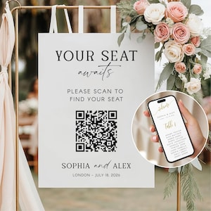以下が含まれることがあります： 「YOUR SEAT awaits」と「PLEASE SCAN TO FIND YOUR SEAT」の文字が入った白いウェディングサイン。テキストの下にはQRコードがあります。サインには「SOPHIA and ALEX」と日付「LONDON - JULY 18, 2026」も含まれています。スマートフォンには座席表が表示されています。