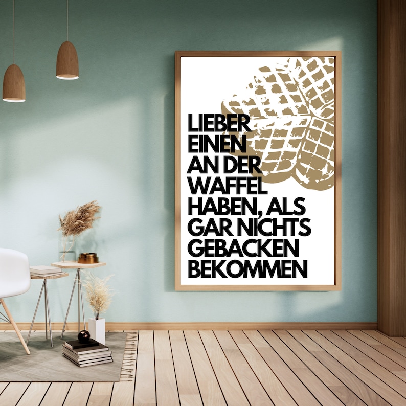May include: A white poster with a black and white graphic of a waffle. The text on the poster reads "Lieber einen an der Waffel haben, als gar nichts gebacken bekommen."