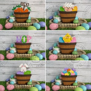 May include: A set of six wooden Easter egg baskets with different themes. The baskets are decorated with painted eggs, a chick, a bunny, jelly beans, carrots, and the word "HOP".
