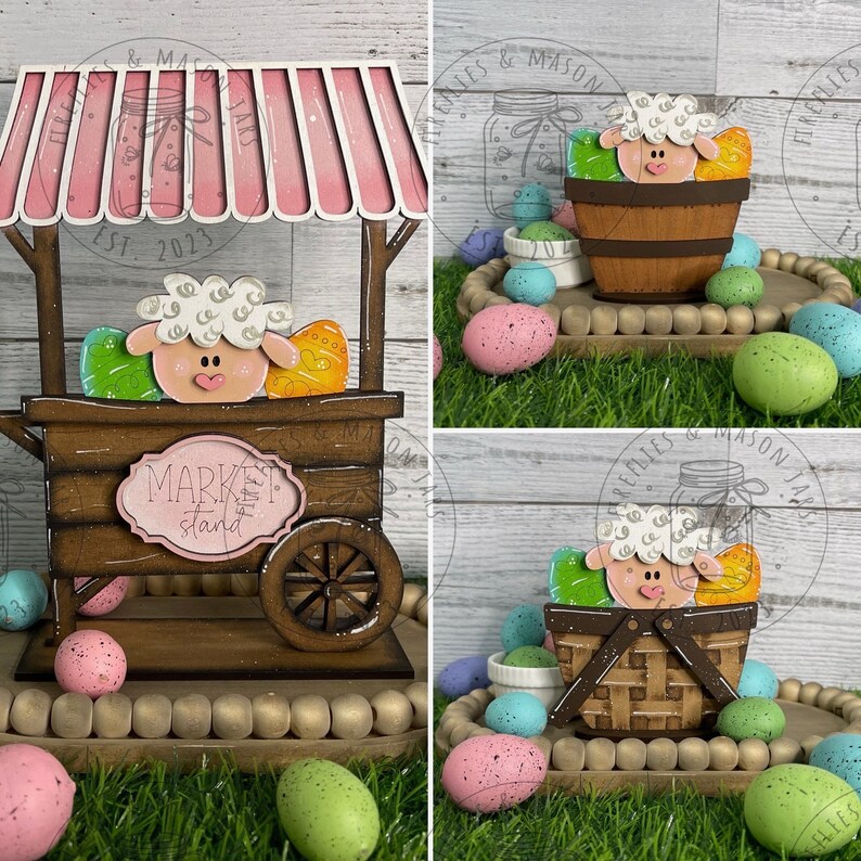 May include: A wooden market stand with a pink striped awning, featuring a white sheep with brown eyes and a pink nose. The stand is decorated with colourful Easter eggs and a sign that reads "Market Stand".