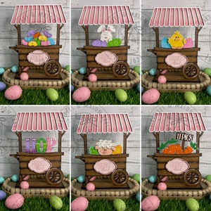May include: Six wooden market stalls decorated for Easter. Each stall has a pink and white striped awning and a sign that says "Market Stand". The stalls are decorated with different Easter themes, including jelly beans, a bunny, a chick, the word "HOP", a sheep, and carrots.