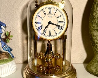 Working vintage Kundo battery operated anniversary clock with glass dome. Made in Germany.