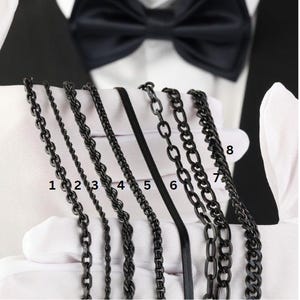 May include: Eight different black chain styles numbered 1 through 8. The chains are laid out on a white surface.