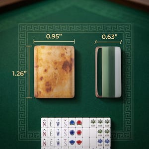 May include: A rectangular tile with a mottled brown finish measuring 0.95 inches by 1.26 inches, a rectangular frame with a green and white striped insert measuring 0.63 inches wide, and a set of white mahjong tiles featuring the letters N, E, W, S, lotus flowers, and the word JOKER.