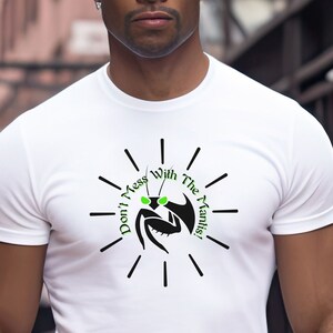 May include: White t-shirt with a black and green praying mantis graphic. The mantis is wearing sunglasses and the text "Don't Mess With The Mantis!" is written in a circle around it.