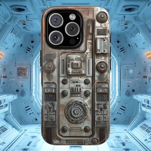May include: A detailed phone case with a metallic, industrial design. The case features a complex arrangement of circular and rectangular elements, resembling a control panel or spaceship interior. The case has a weathered, aged appearance, with a camera module at the top.