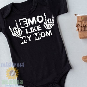 May include: Black baby bodysuit with the text "EMO LIKE MY MOM" in white. The design includes white skeleton hands making the rock and roll hand gesture. The bodysuit is short-sleeved.