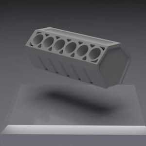May include: A light grey, rectangular engine block model featuring six circular cylinder openings arranged in a single row along the top surface, with a flat, hexagonal end panel and a solid, geometric structure throughout the entire object.