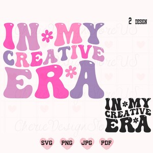 May include: Two designs of the phrase "In My Creative Era" in a retro font. The first design is in pink, purple, and white with flowers. The second design is in black with a bold font.