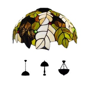 May include: A stained glass lampshade with a leaf design in shades of green, white, and brown. The lampshade is dome-shaped and features a variety of leaf shapes. Silhouettes of three different lamp styles are below the lampshade.