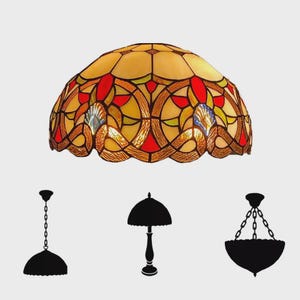 May include: A stained glass lampshade with a domed shape, featuring a mosaic of yellow, red, and blue glass pieces. The design includes intricate patterns and a scalloped edge. Silhouettes of different lamp styles are below.