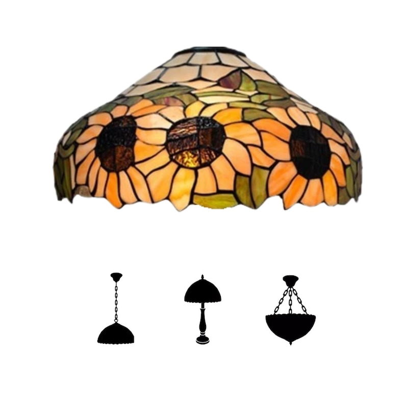 May include: A stained glass lamp shade featuring a sunflower design with yellow, orange, and brown hues. The shade has a scalloped edge and is surrounded by green leaves. Three silhouette lamp styles are shown below the shade.