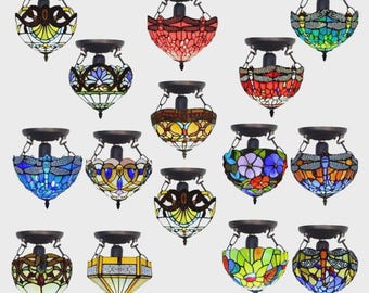 May include: A collection of stained glass ceiling lights in various colors and designs. Each light features a decorative metal frame and a unique pattern, including dragonflies and floral motifs. The lights are designed for ceiling mounting.