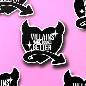 May include: Black and white heart-shaped sticker with devil horns and a tail. The sticker says "Villains Make Books Better".
