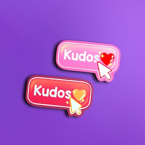 Puede incluir: Dos pegatinas de botón rosa y rojo con la palabra "Kudos" y un corazón con un efecto de brillo. Un cursor blanco apunta al corazón.