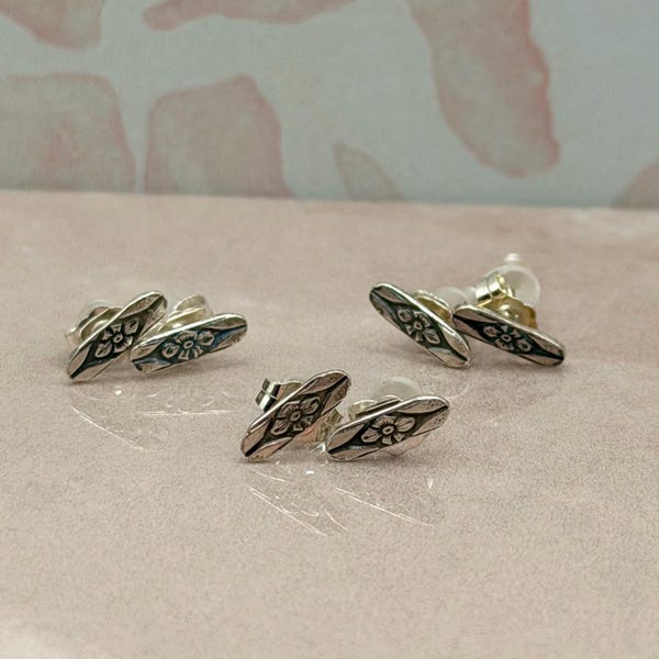 Sterling silver studs pair with a floral design• Solid silver handmade earrings for everyday wear•