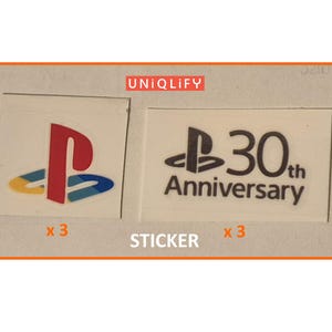 May include: Two white stickers with the PlayStation logo and "30th Anniversary" text. The PlayStation logo is red, blue, and yellow. The stickers are labeled "x 3" and "STICKER". The word "UNIQLIFY" is in the top left corner.