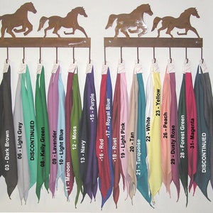 May include: A rack of 33 different colored bandanas, hanging from hooks. The bandanas are arranged in a row, with the colors ranging from black to charcoal. The bandanas are labeled with numbers and color names.