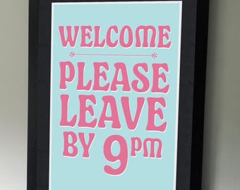 May include: A framed print with a light blue background and pink text that reads "Welcome Please Leave By 9pm".