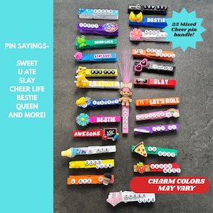 May include: A collection of colorful cheer pin charms with various phrases like "Bestie", "Sweet", and "Good Luck". The pins feature diverse designs, including flowers, pizza slices, and cartoon characters. A bundle of 25 mixed cheer pins.