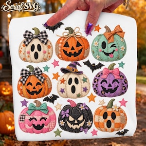 May include: A white fabric surface featuring a colorful Halloween-themed graphic print of nine stylized pumpkins and ghosts. The design includes various patterns like plaid, leopard print, and polka dots, accented with bows, hats, and small stars.