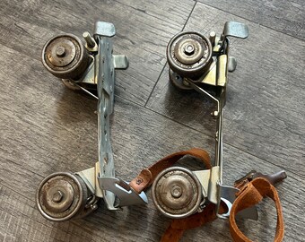 Vintage Heavy Metal Adjustable Roller Skates- with straps, one strap broken , silver metal, brown straps- unique decor , vintage goods